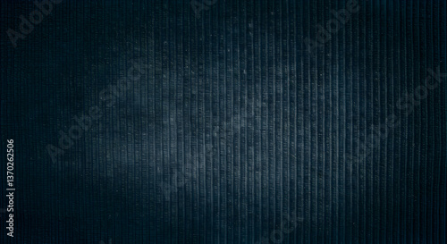 Navy blue corduroy textile close-up with worn texture and vertical ribs