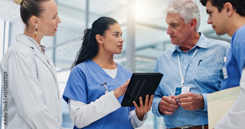 Woman, doctors and tablet with team at hospital with discussion for funding, management and review. People, leader and group with surgeon, problem solving and feedback with app at wellness clinic photo