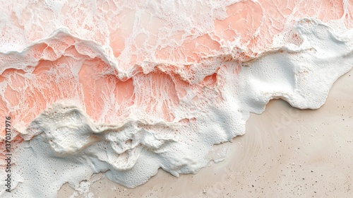 The image is of a beach with pink and white waves. The pink waves are crashing against the white sand, creating a beautiful and serene scene. The colors of the waves