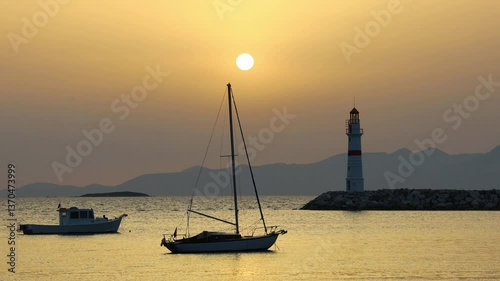 Seascape at sunset. Lighthouse on the coast. Seaside town of Turgutreis and spectacular sunsets	
