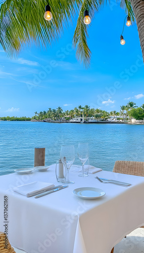 Tranquil waterfront dining setting with ocean view, tablescape, and string lights