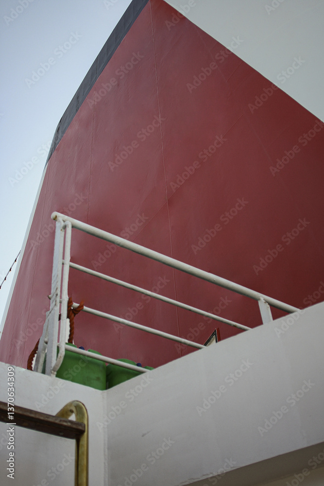 White and red funnel of classic cruise ship cruiseship liner against deep blue sky during cruise in summer