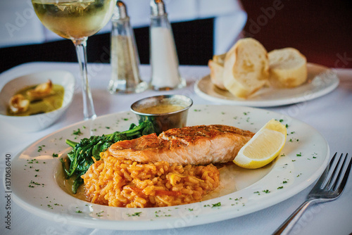 Obraz na płótnie seared salmon fillet on a bed of tomato risotto with a side of sautéed spinach