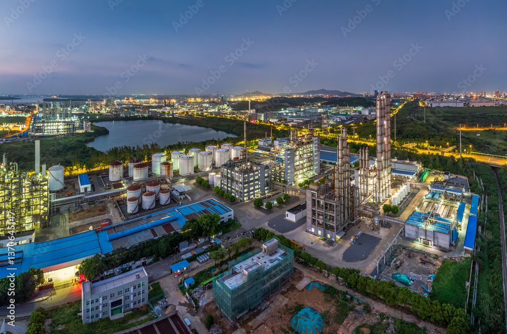Fototapeta premium Aerial view of large oil refinery factory complex at dusk