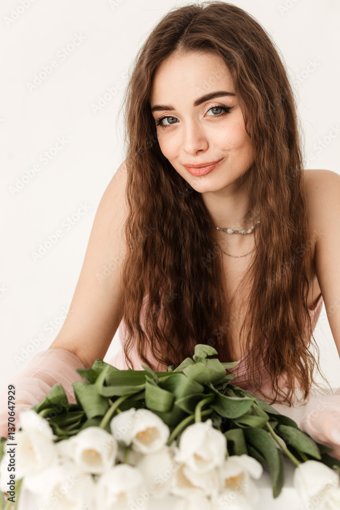 young european lady hugs bouquet of white tulips on chest, enjoys spring holiday, isolated on white background, studio. Women's day gift, congratulation, anniversary, date young european lady hugs bouquet of white tulips on chest, enjoys spring holiday, isolated on white background, studio. Women's day gift, congratulation, anniversary, date