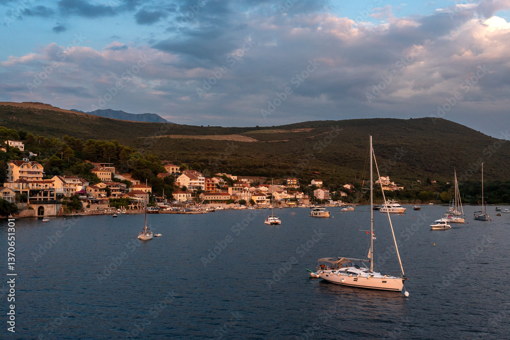 Fototapeta premium Aerial view of little fisher village bay with yachts and catamarans
