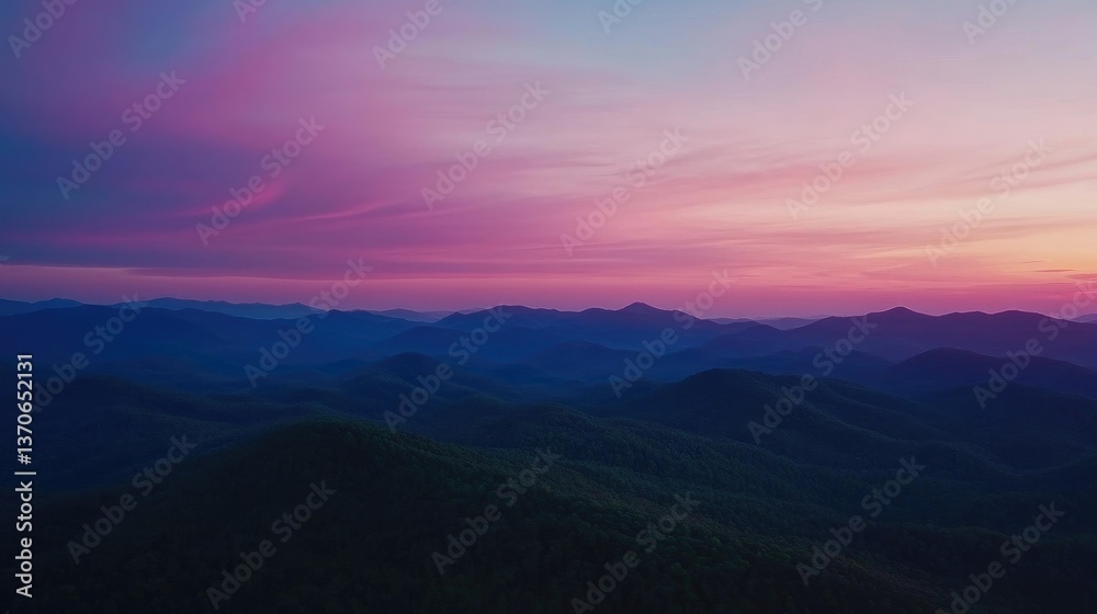Beautiful aerial shot of mountains under a pink and blue sky Beautiful aerial shot of mountains under a pink and blue sky
