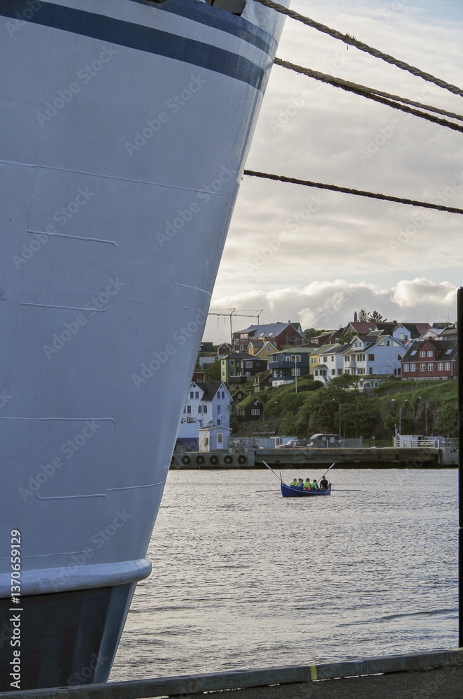 Classic expedition cruiseship cruise ship liner Delphin docked at terminal in Thorshavn Thorshaven, Faroe Islands with city skyline fjord landscape in background during Arctic Circle summer cruising