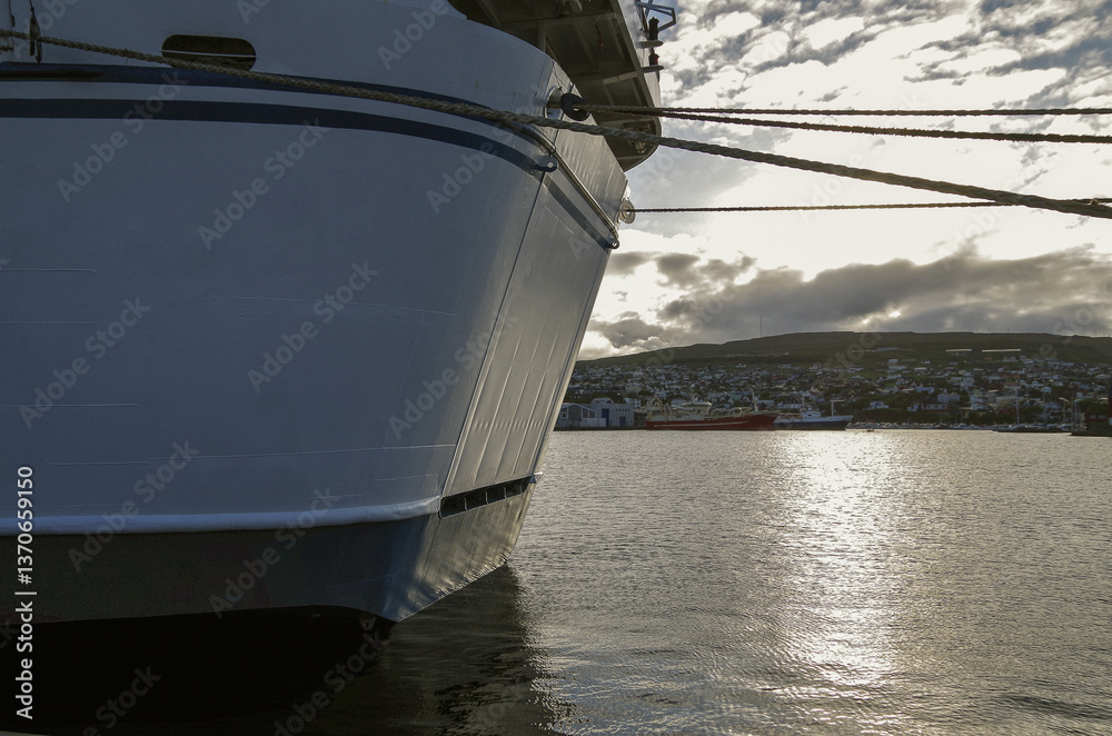 Classic expedition cruiseship cruise ship liner Delphin docked at terminal in Thorshavn Thorshaven, Faroe Islands with city skyline fjord landscape in background during Arctic Circle summer cruising