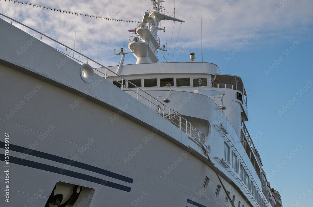 Classic expedition cruiseship cruise ship liner Delphin docked at terminal in Thorshavn Thorshaven, Faroe Islands with city skyline fjord landscape in background during Arctic Circle summer cruising