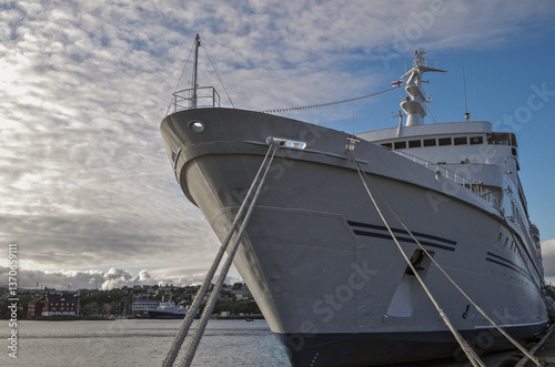 Obraz na płótnie Classic expedition cruiseship cruise ship liner Delphin docked at terminal in Thorshavn Thorshaven, Faroe Islands with city skyline fjord landscape in background during Arctic Circle summer cruising w salonie