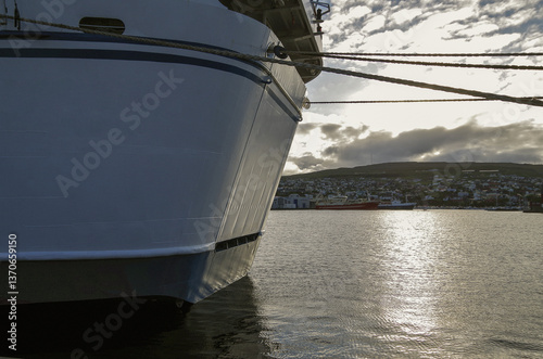 Obraz na płótnie Classic expedition cruiseship cruise ship liner Delphin docked at terminal in Thorshavn Thorshaven, Faroe Islands with city skyline fjord landscape in background during Arctic Circle summer cruising w salonie