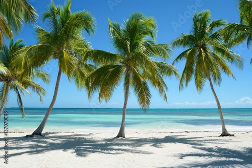 Serene tropical paradise with swaying palm trees on a pristine white sand beach under a vibrant blue sky, bathed in warm sunlight.