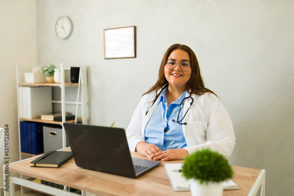 Confident plus-size female physician working at laptop, displaying professional demeanor in modern medical workspace Confident plus-size female physician working at laptop, displaying professional demeanor in modern medical workspace