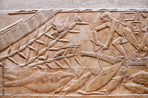 Precise depiction of boat fishing from the tomb of Kagemni showing a man in a reedbow, various fish in the river Nile, plant with a grasshopper and a frog, Saqqara, Egypt