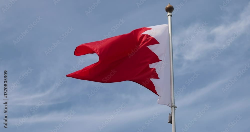 Bahrain Flag. National Flag of Bahrain fluttering in the wind. Close-up. Great for news. Bahrain flag against blue sky. 4K video.