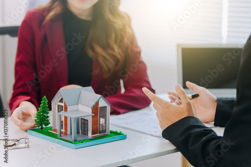 Businessman, house and condo sales representative Hand over the keys to the customer and sign the sales or rental contract according to mutual agreement in the office. Real estate business concept
