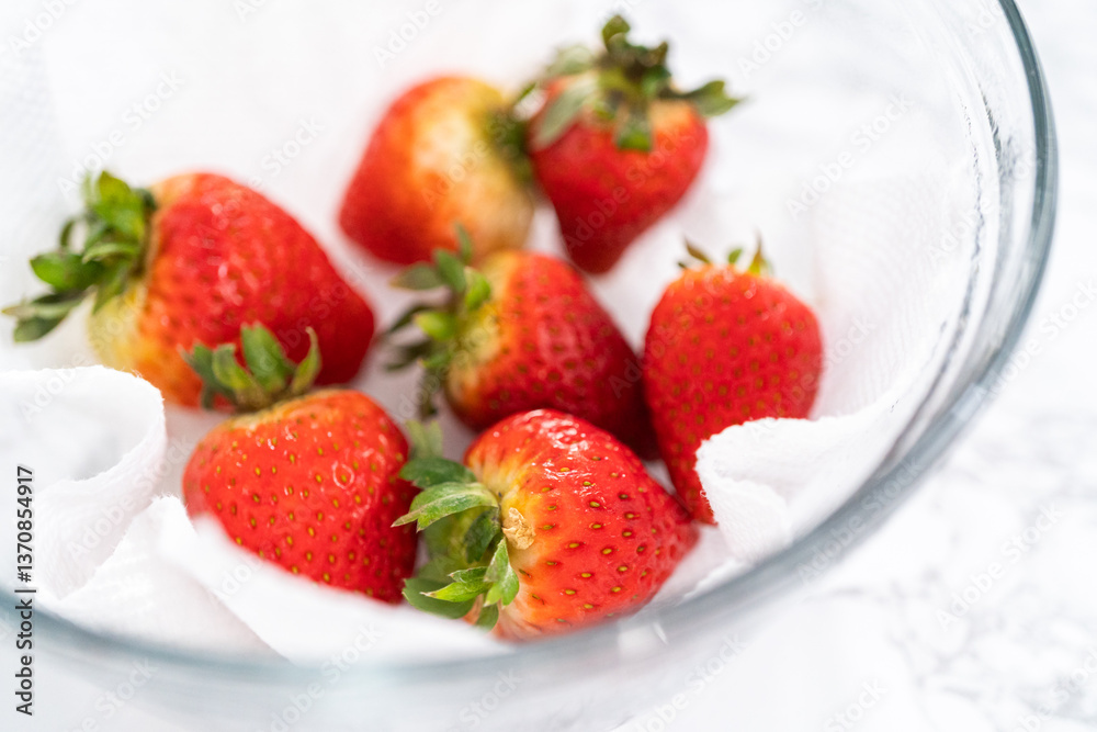 Washed and Dried Strawberries Neatly Stored in a Glass Bowl Washed and Dried Strawberries Neatly Stored in a Glass Bowl