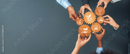 This image showcases diverse hands collaboratively holding gear icons, symbolizing the integration of green business initiatives and sustainability in a modern professional environment. Amity photo