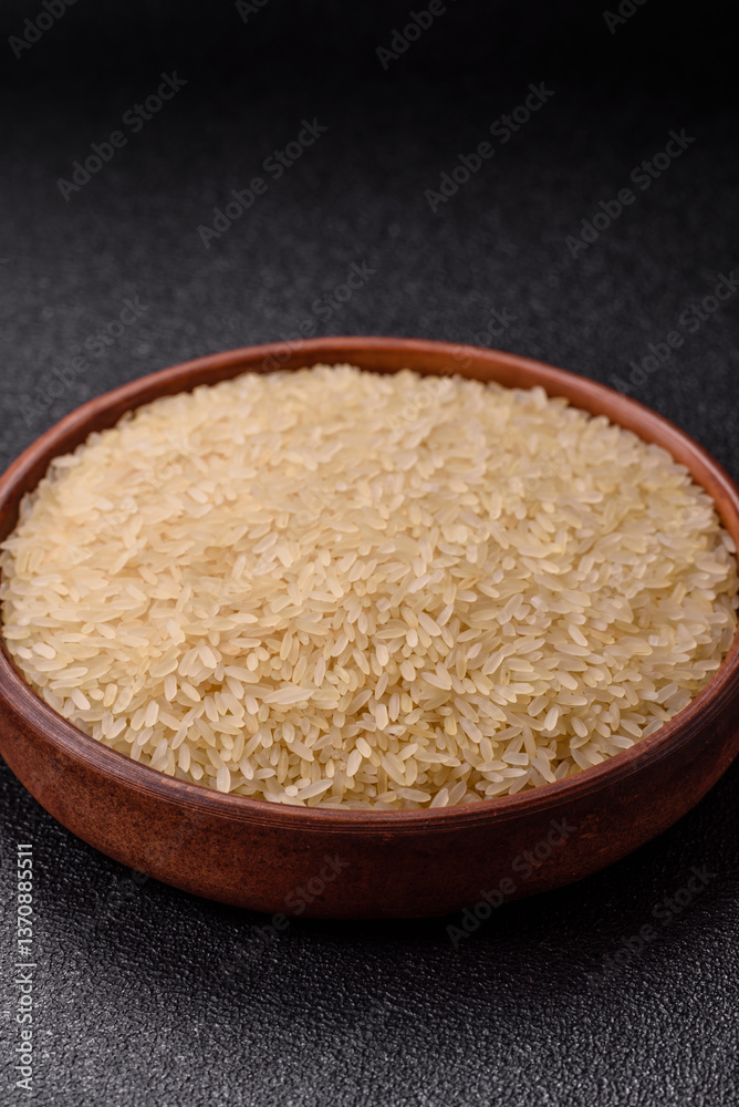 White raw rice in a ceramic bowl. Rice as an ingredient White raw rice in a ceramic bowl. Rice as an ingredient