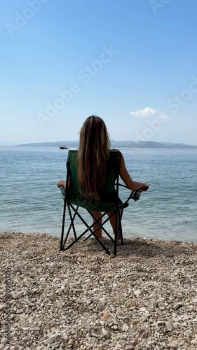 young woman sitting on the beach