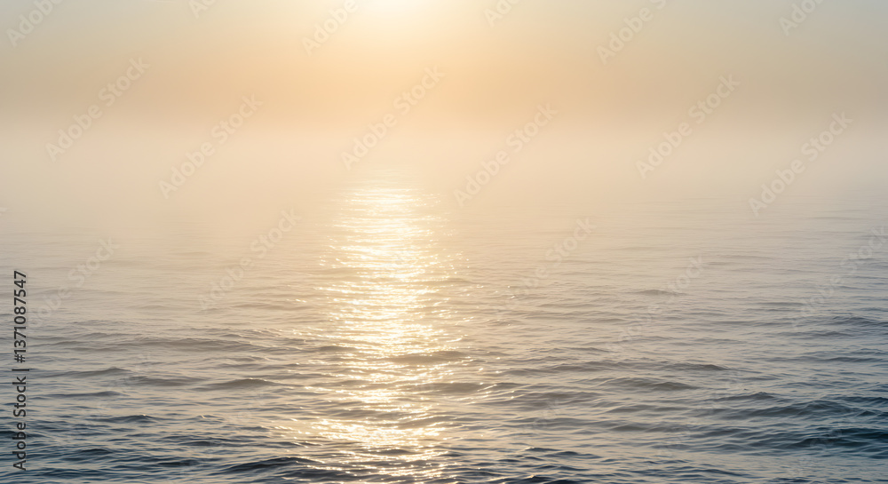 Fototapeta premium Ephemeral beauty: sunlit ocean veiled in ethereal morning mist horizon