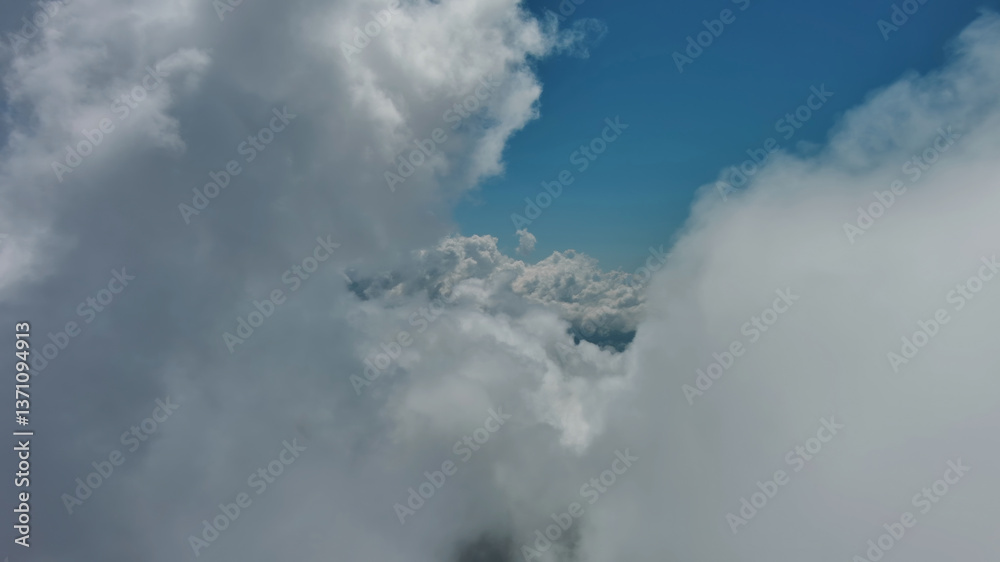 Obraz premium Flying through white fluffy clouds