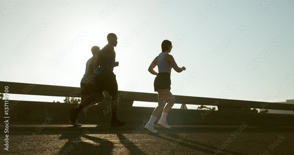 Fitness, people and group with running on bridge for marathon training, exercise and race performance. Sunlight, runner club and cardio in road for wellness competition, morning jog and workout pace