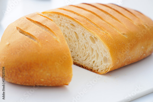 Golden-Brown Loaf of Bread Cut to Reveal Its Fluffy Texture