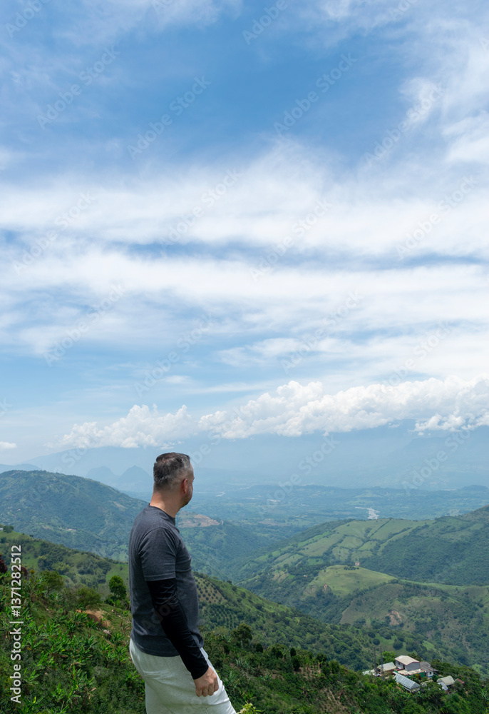 Naklejka premium A Mature Latino Man, with Gray Hair, Taking in the Breathtaking Scenery of the Colombian Mountains
