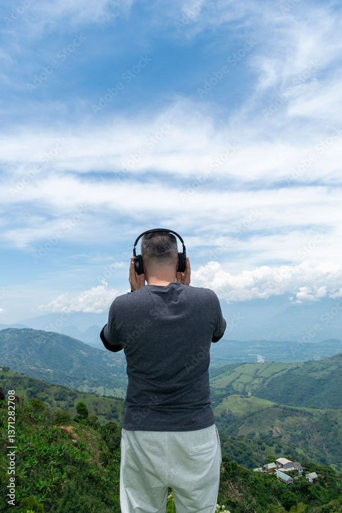 Naklejka premium A Mature Latino Man, with Gray Hair, Taking in the Breathtaking Scenery of the Colombian Mountains