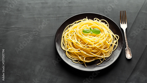 Dark plate with italian spaghetti on dark.