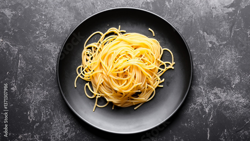Dark plate with italian spaghetti on dark.