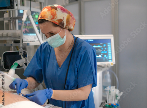 Nurse placing iv catheter into patient's arm in hospital room