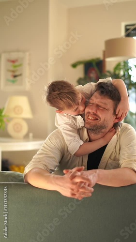 6 year old boy hugs dad and plays with him