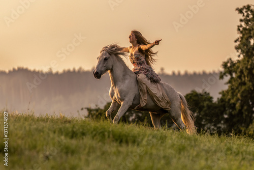 Obraz na płótnie A female equestrian and her horse interacting together. Romantic freedom sunset scene w salonie