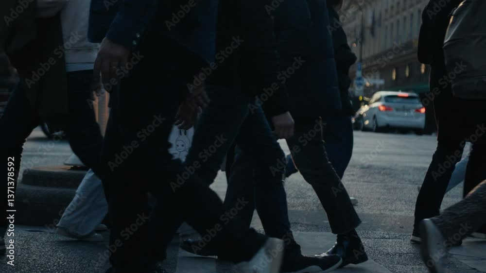 People crossing a parisian street at sunset People crossing a parisian street at sunset