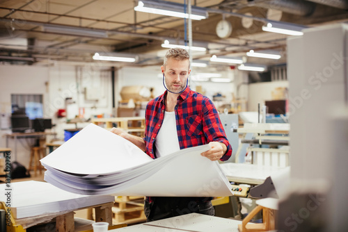Mid adult man working in a printing press office
