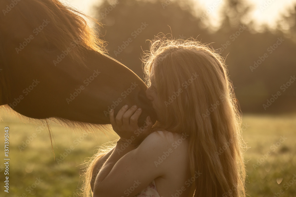 A female equestrian and her horse interacting together. Romantic freedom sunset scene