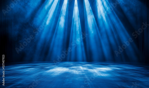 Blue illuminated stage with light rays and smoke creating a dramatic and mysterious atmosphere