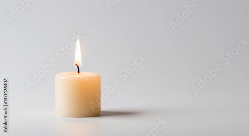 Wallpaper Mural  single candle burning softly in the center of a plain white background Torontodigital.ca