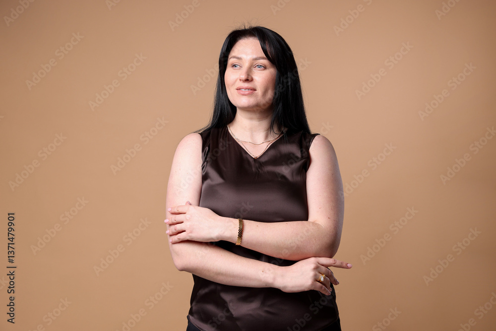 Obraz premium Portrait of smiling plus size model on beige background. Overweight