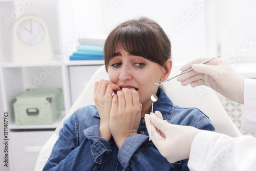 Schilderij op canvas Scared woman having appointment with dentist in clinic
