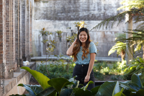 Young Asian woman enjoying time outdoors at enclave