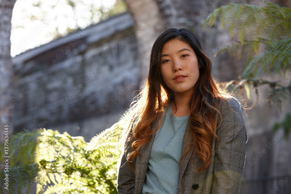Young Asian woman enjoying time outdoors at enclave Young Asian woman enjoying time outdoors at enclave