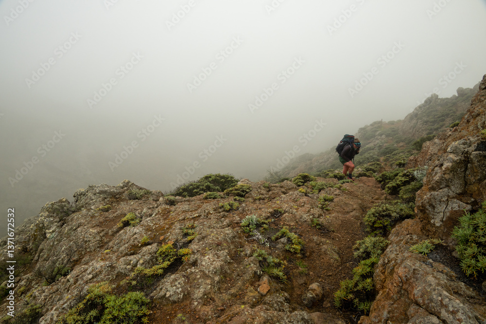 Woman Takes Big Steps up Steep Montanon Ridge