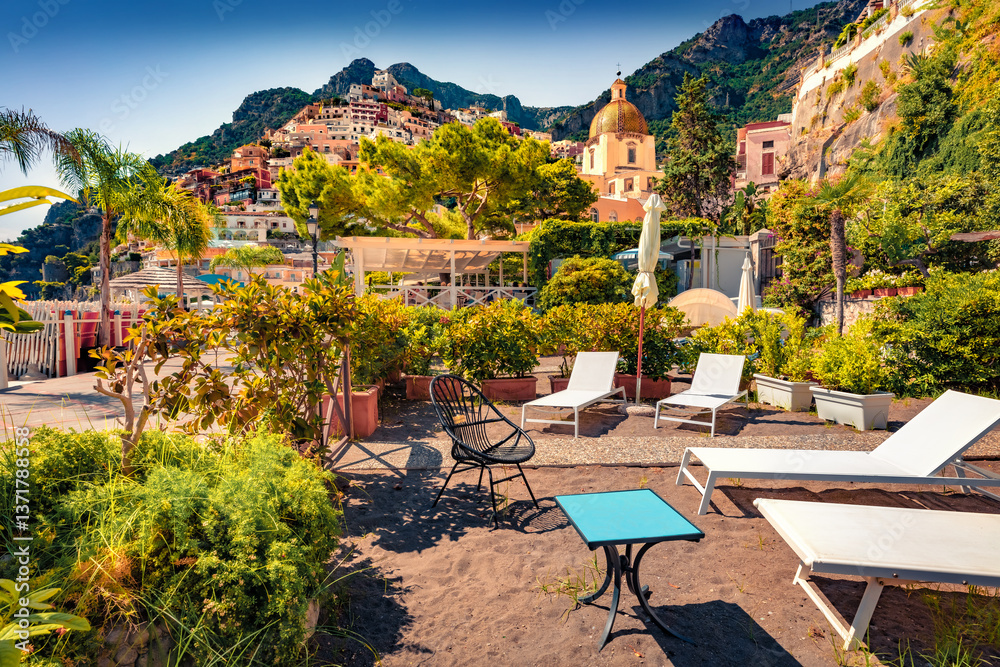 Superb summer scene of sunny yard in cliffside village on southern Italy's Amalfi Coast - Positano. Sunny morning view of Mediterranean sea resort. Vacation concept background.