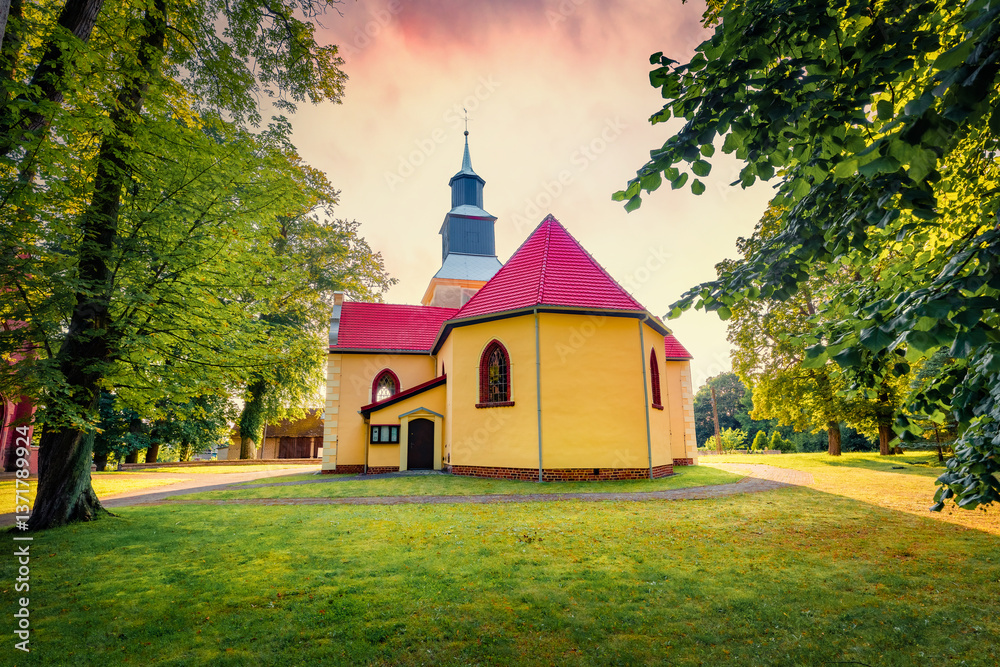 Gorgeous summer sunset on Stanislawa Kostki Catholic church. Stunning evening cityscape of Karnice village, Gryfice County, West Pomerania, Poland, Europe. Traveling concept background.