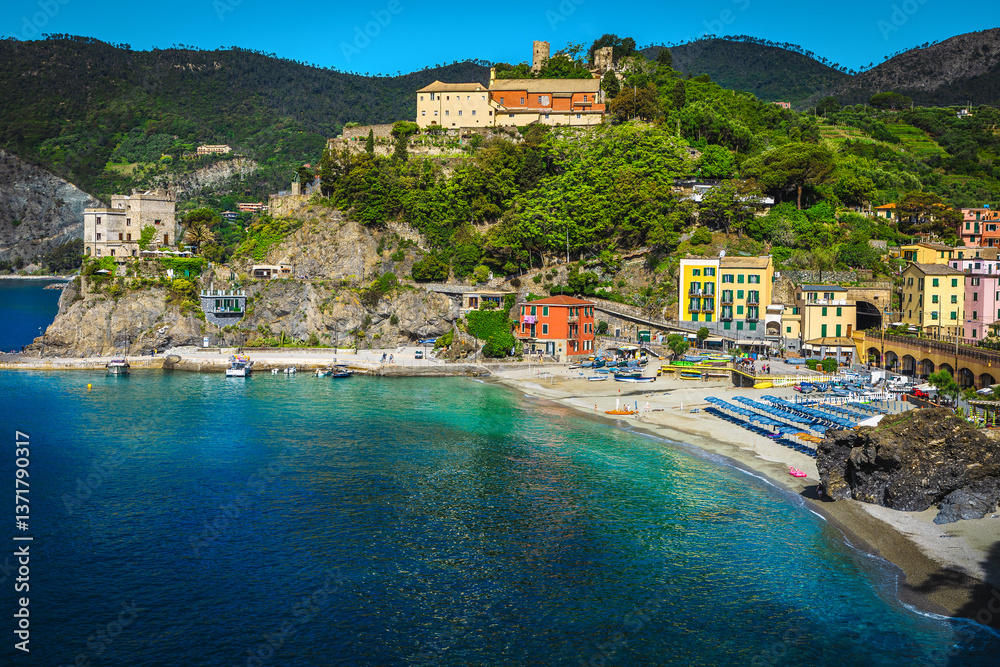Ligurian beach with colorful parasols in row, Cinque Terre, Italy
