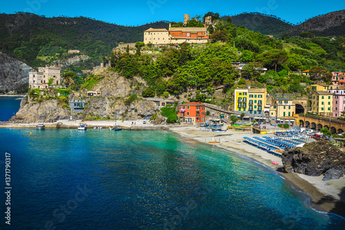 Ligurian beach with colorful parasols in row, Cinque Terre, Italy